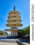 People sitting in shade under Peace Pagoda in Japantown on bright summer day with clear blue sky