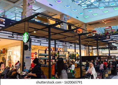 People Sitting, Waiting In Line And Working At The Starbucks At AFI Cotroceni Mall From Bucharest, Romania, 2020