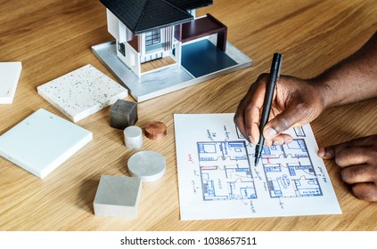 People sketching house plan blueprint