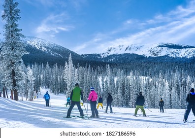 People Skiing In The Mountains In Colorado Ski Resort On Nice Winter Day