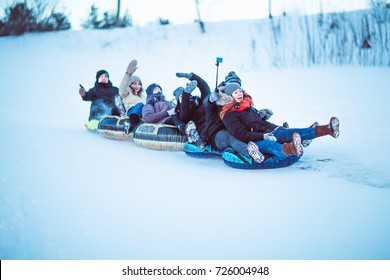 People Slide Down From The Snow Hill.