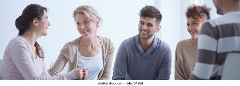 People smiling being happy about successful group therapy for addicted