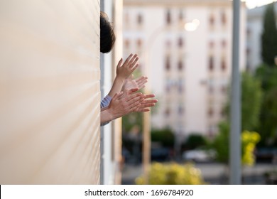 People In Spain Clapping In The Window In Support Of People Who Fight Against The Coronavirus