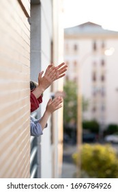 People In Spain Clapping In The Window In Support Of People Who Fight Against The Coronavirus