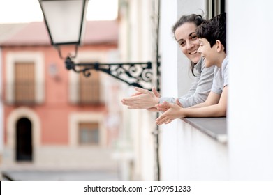 People In Spain Clapping In A Window In Support Of People Who Are Fighting Against Coronavirus