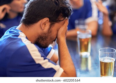 People, Sport And Fail Concept - Close Up Of Sad Football Fan At Bar Or Pub