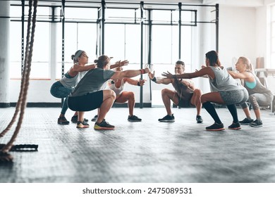 People, squating and workout together in gym for body wellness, group and exercise for leg strength. Balance, determination and core power or abdominal training or calves, challenge for fitness class - Powered by Shutterstock