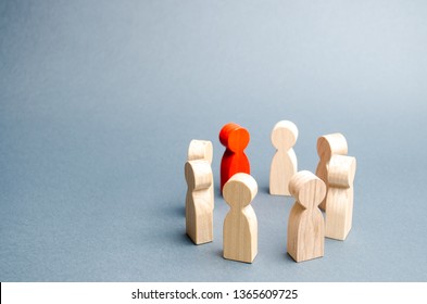 People Stand In A Circle On A Gray Background. Communication. Business Team, Teamwork, Team Spirit. Wooden Figures Of People. A Circle Of People. Discussion, Cooperation, Cooperation. Selective Focus