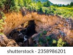 People stand near the river running through Tonto Natural Bridge in Payson Arizona