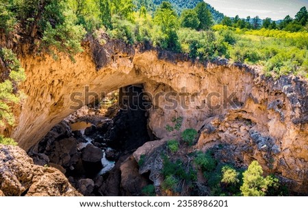 People stand near the river running through Tonto Natural Bridge in Payson Arizona