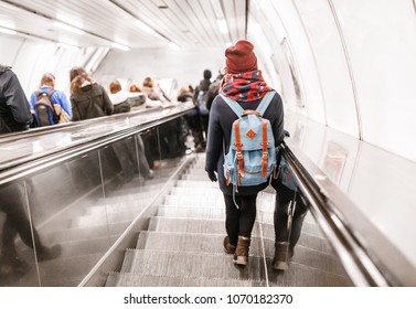 People stand on the escalator in the metro or subway, the concept of public urban underground transport