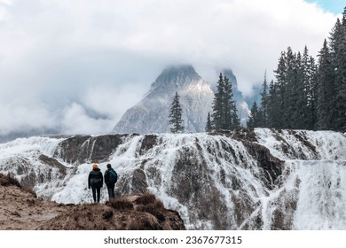 People standing in front of Wapta Falls. - Powered by Shutterstock