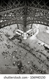 People standing in line under the Eiffel Tower in Paris