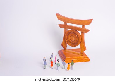 People Are Standing Near The Sights. A Crowd Of Tourists Looking At The Chinese Japanese Gates. The Concept Of Travel And Tourism, Outdoor Activities, Cultural Exchange And The Of Other Civilizations