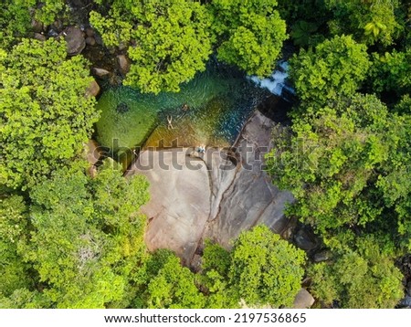 People sunbaking and swimming at Josephine Falls. Aerial view
