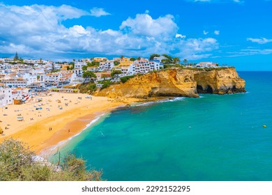 People are sunbathing on Praia de Carvoeiro beach in Portugal. - Powered by Shutterstock