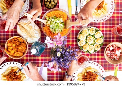 People At Sunday Brunch For Caucasian Family. All Together Outdoor Toasting With A Rose Wine. Rustic Corner With Wooden Table And Checkered Tablecloth. Vegetarian Food.