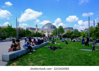 People Take A Lunch Break In A Park During A Hot Day In Paris, France On April 25, 2022.