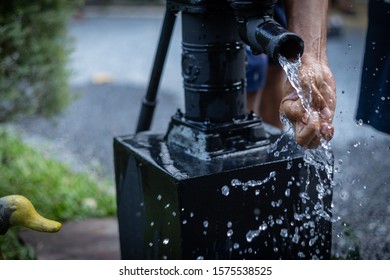 People Take Their Hands To Support The Water Coming From Groundwater Pump