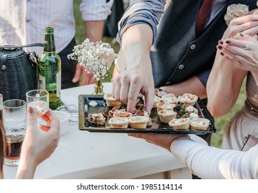 People Taking Canapes From Tray At Wedding Reception 