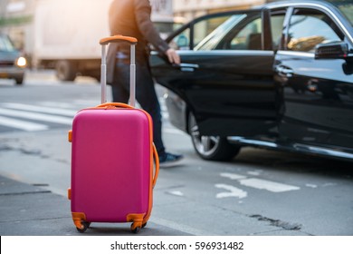 People Taking Taxi From An Airport And Loading Carry-on Luggage Bag To The Car. Luggage On The City Street. Travel Concept.