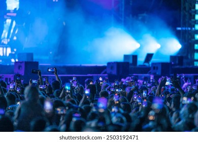 People taking a Video With Smartphones at Concert - Powered by Shutterstock