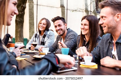 People tasting hot drinks at coffee restaurant dehor - Milenial friends talking and having fun together at sidewalk cafe - Life style concept with happy men and women at bar cafeteria on bright filter - Powered by Shutterstock