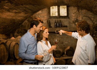 People Tasting Wine In Cellar