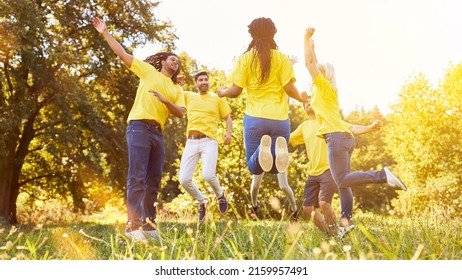 People As A Team Jump Together At Team Building Exercise In Nature