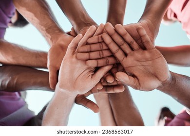 People, teamwork and hands together in collaboration, goals or community for motivation below. Closeup of group piling in team building, solidarity or trust in support for sports, rugby or match - Powered by Shutterstock