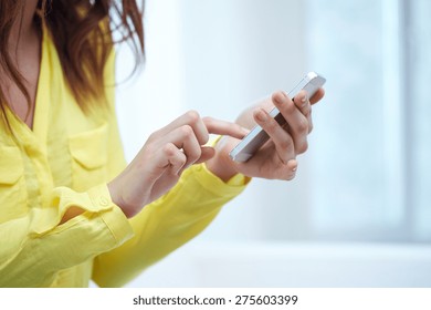 people, technology and internet concept - close up of teenage girl hands with smartphone at home - Shutterstock ID 275603399