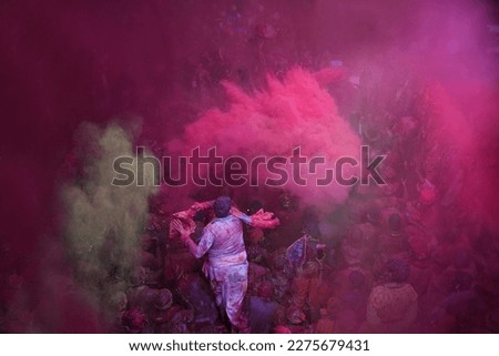 People throw colors at each other during Holi celebrations at the Radha Rani Temple on February 28, 2023 in Barsana, India. Holi is the most celebrated religious festival in India.