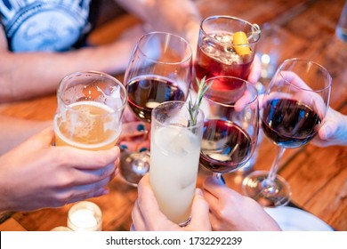 People toasting (cheers) with their drinks at a restaurant or bar - Powered by Shutterstock