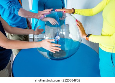 People Touch The Plasma Ball Causing Sparks Of Energy At The Museum Of Sciences