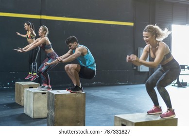 People training jumping on boxes