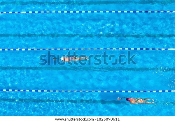 People training in\
swimming pool, top view