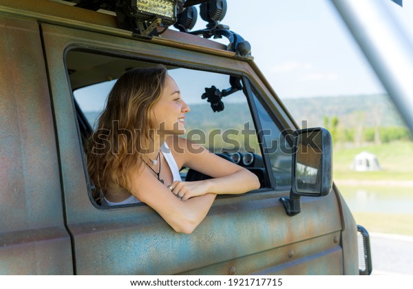 People travel alone with car and tent for free\
camping lifestyle - alternative adventure holiday vacation,\
enjoying the fresh air ,blue sky and green forest in summer,\
looking outside the\
vehicle