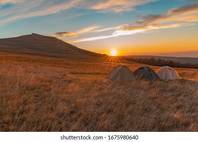 People Travel Life Style Concept Wallpaper Picturesque Photography Three Tents Camp Side Place In Highland Carpathian Mountain Landscape Environment In Romantic Time Sunset Orange Lighting Sun Glares