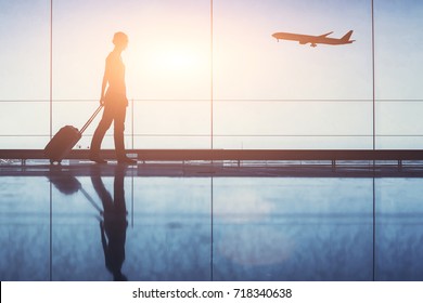 People Traveling, Silhouette Of Woman Passenger With Baggage In Airport