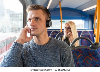 People Travelling By Bus In London And Keeping Social Distance - Man And Woman Commuting On Empty Bus In The City And Keeping Safe Distance - Lifestyle And Travel During Coronavirus Pandemic