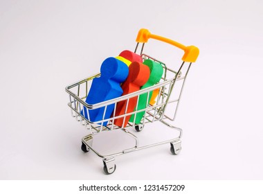 People In A Trolley For A Supermarket. Concept Of Human Trafficking, Modern Slavery. Buying People Is A Violation Of International Laws. Freedom And Deprivation Of Human Rights