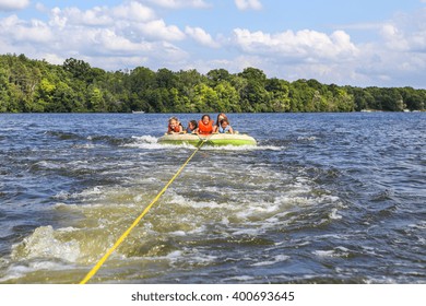 People Tubing On An Inland Lake