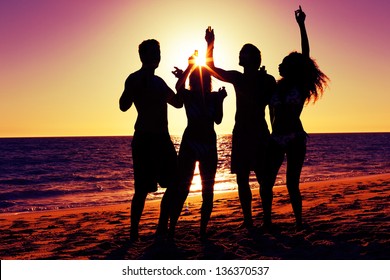 Two couples nude on the beach