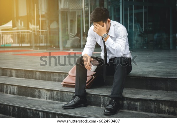 People unemployed\
businessman stress sitting on stair, concept of business failure\
and unemployment\
problem.