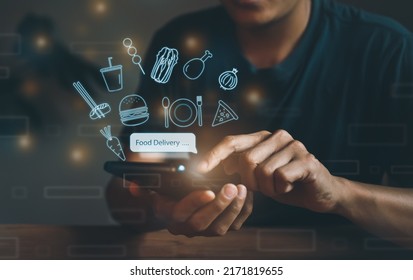 People use mobile phones to place online restaurant orders, delivery, technology, internet, food burger icons, pizza, coffee, chicken, sushi, vegetables, noodles, service meal food menu online at home - Shutterstock ID 2171819655