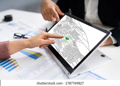 People Using Cadastral Survey Map On Tablet Screen