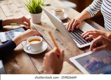 People using different devices at one table