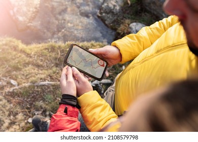 people using gps navigator app, forest hiking, couple on mountain at sunset - Powered by Shutterstock