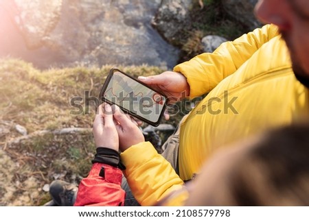 people using gps navigator app, forest hiking, couple on mountain at sunset