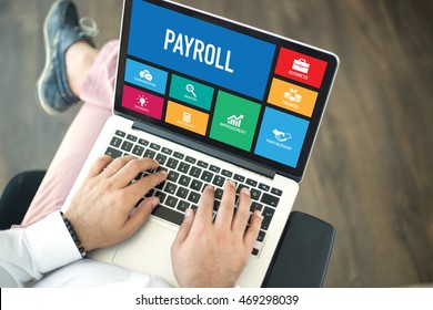 People Using Laptop In An Office And PAYROLL Concept On Screen